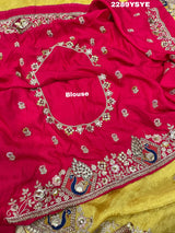 A yellow Banarasi silk saree with Bollywood style embellishments including sequins and a distinctive pattern.