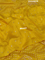 A yellow saree with bandhani style embellishments and zari work