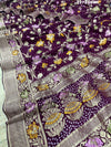 A purple georgette saree with a Meenakari weaving pattern, showing detailed floral designs and a border.