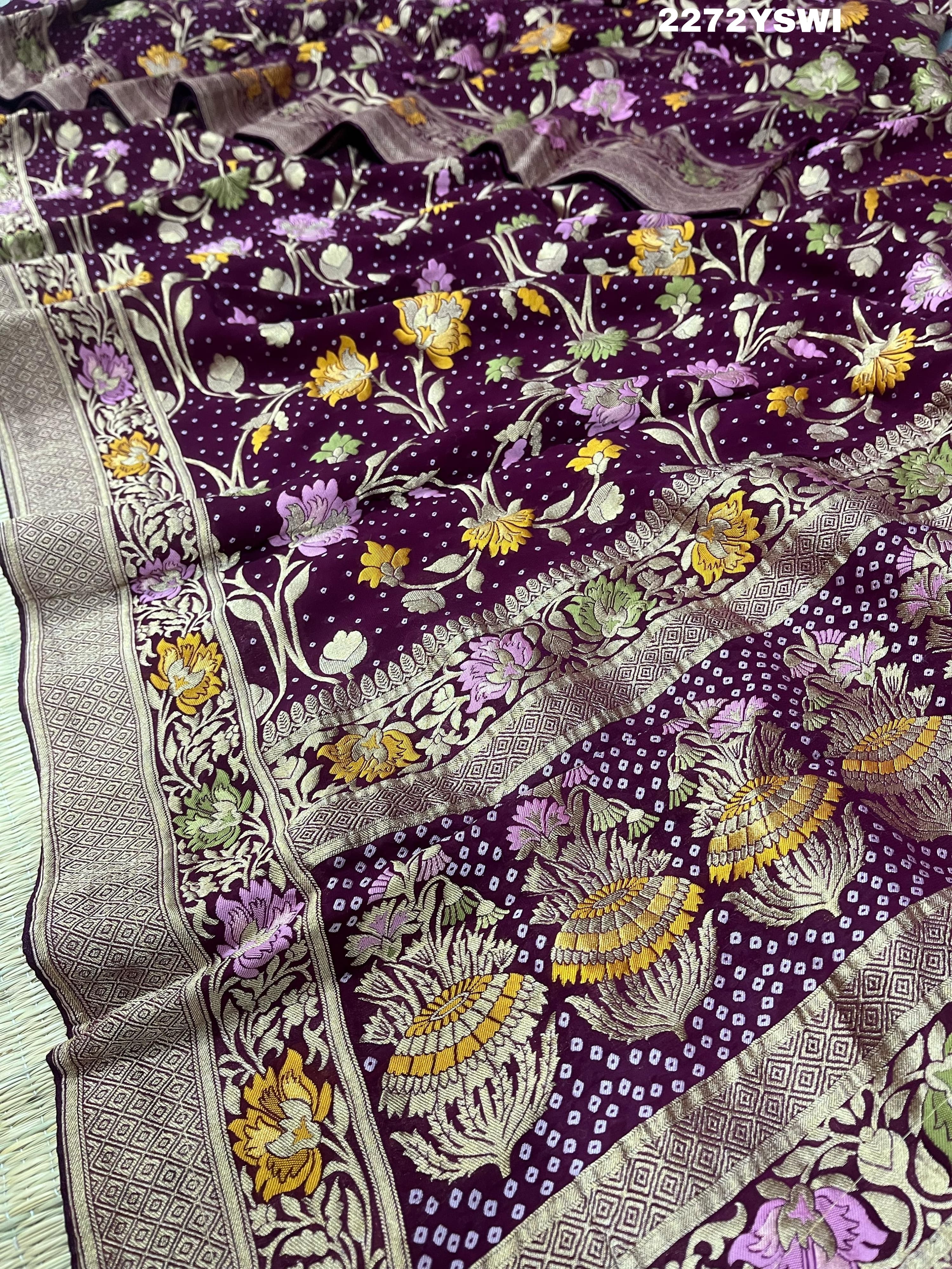 A purple georgette saree with a Meenakari weaving pattern, showing detailed floral designs and a border.