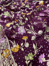 A purple georgette saree with a Meenakari weaving pattern, showing detailed floral designs and a border.