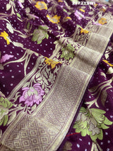 A purple georgette saree with a Meenakari weaving pattern, showing detailed floral designs and a border.