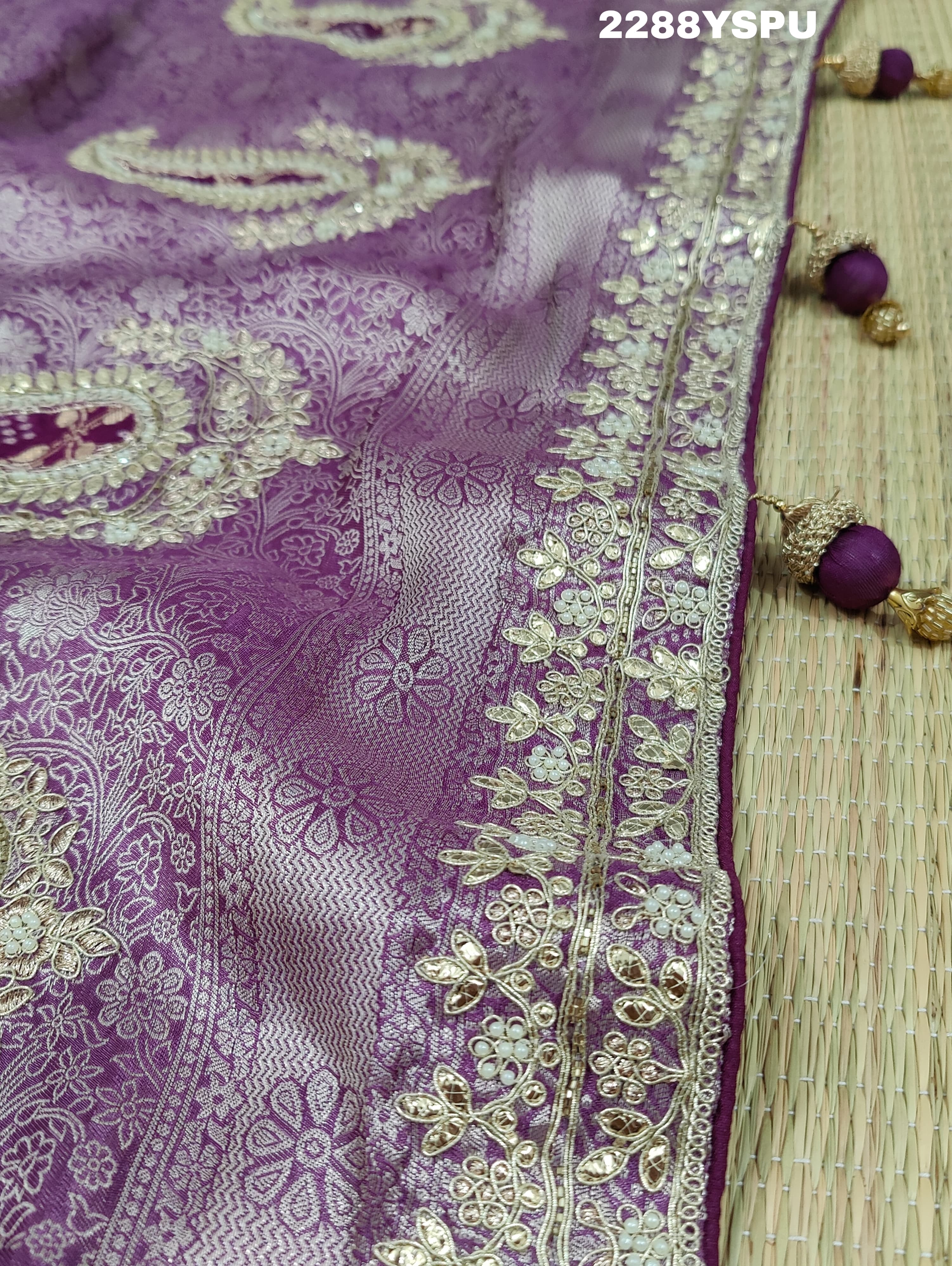 A purple Banarsi silk Bollywood style saree with sequence and gotapatti work, showing detailed patterns and embroidery.