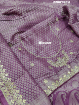 A purple Banarsi silk Bollywood style saree with sequence and gotapatti work, showing detailed patterns and embroidery.