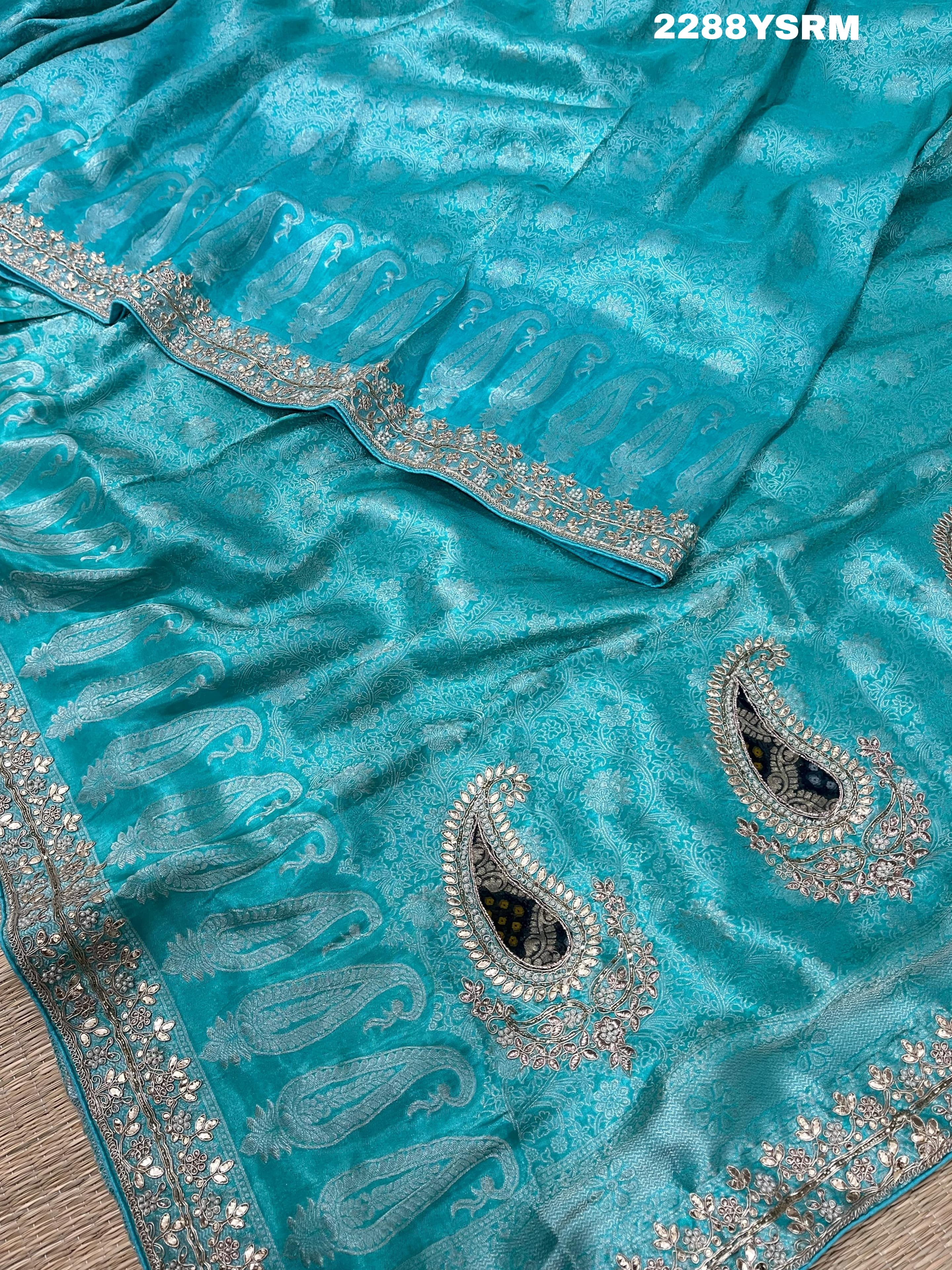 A sea green Banarsi silk Bollywood style saree with sequence and gotapatti work