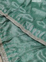 A green Banarsi silk saree with Bollywood style embellishments including sequins and gotapatti work