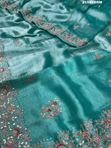 A sea green tissue silk saree with sequence embroidery work in a Bollywood style pattern.