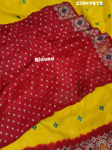 A yellow and red Dola silk saree with Zari weaving and a floral pattern,