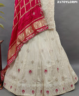 A cream-colored Lehenga with pink and gold embellishments