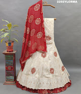 A traditional Indian lehenga with bandhani style patterns in cream and maroon colors