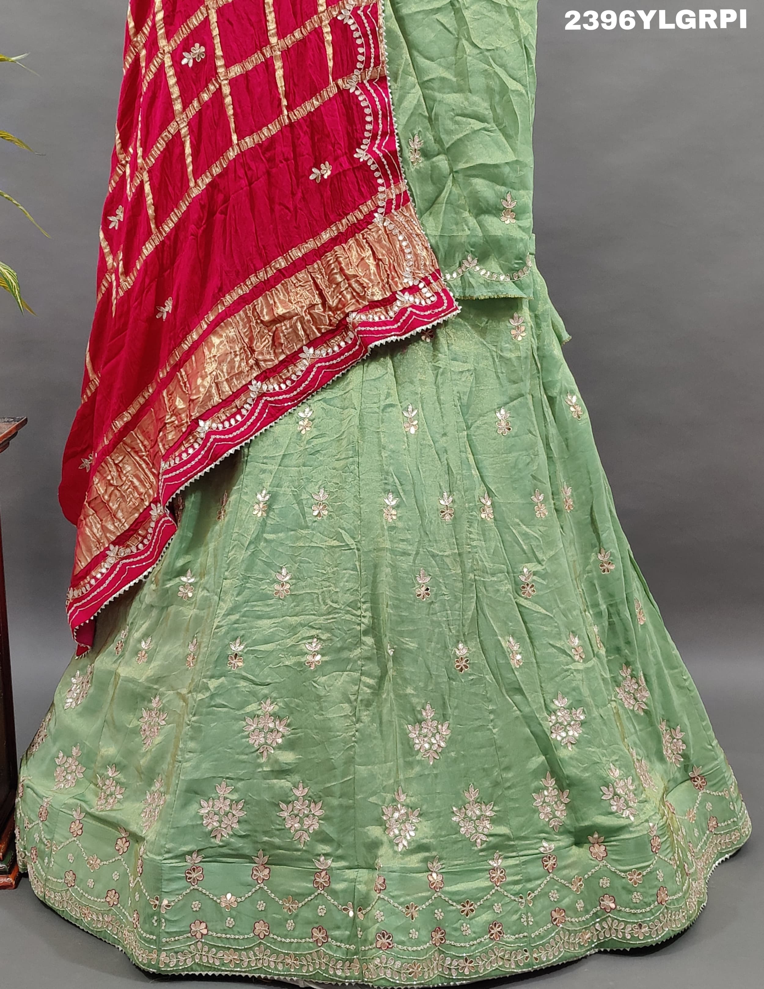 A pista Lehenga with pink gota patti work and a red dupatta