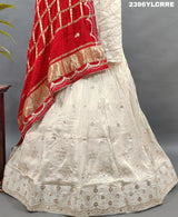 A cream-colored Lehenga with red and gold Gota patti Work 
