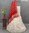 A cream-colored Lehenga with red and gold Gota patti Work 