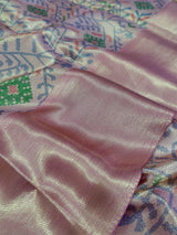  Banarasi silk saree with a printed floral pattern in pink and silver colors, showing detail and texture.
