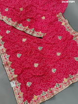 A pink chiffon saree with bandhani pattern and gotapatti work