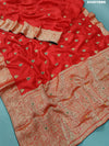 A red Banarasi silk saree with cutdana work and a golden border, 