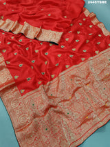 A red Banarasi silk saree with cutdana work and a golden border, 