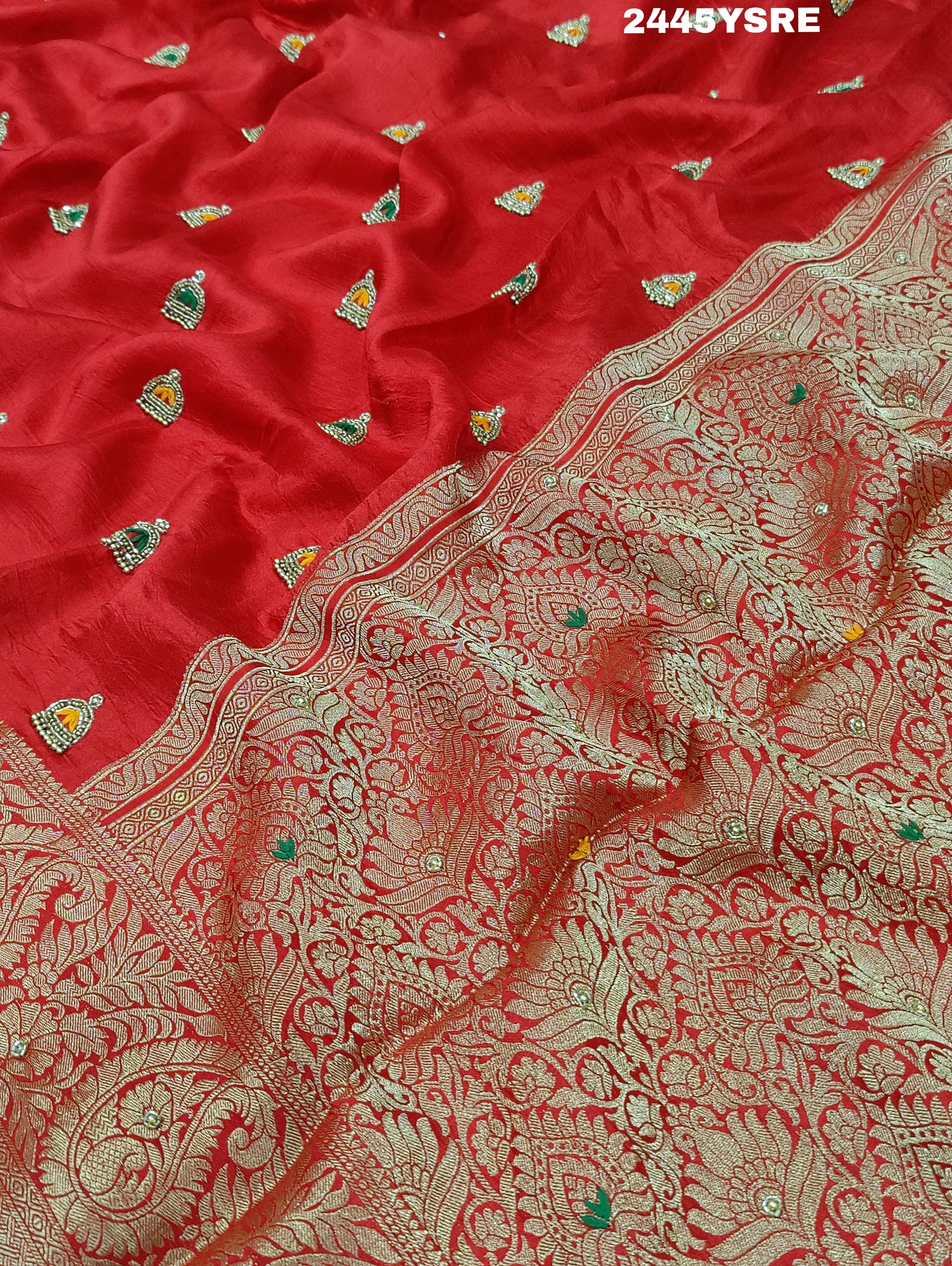 A red Banarasi silk saree with cutdana work and a golden border, 