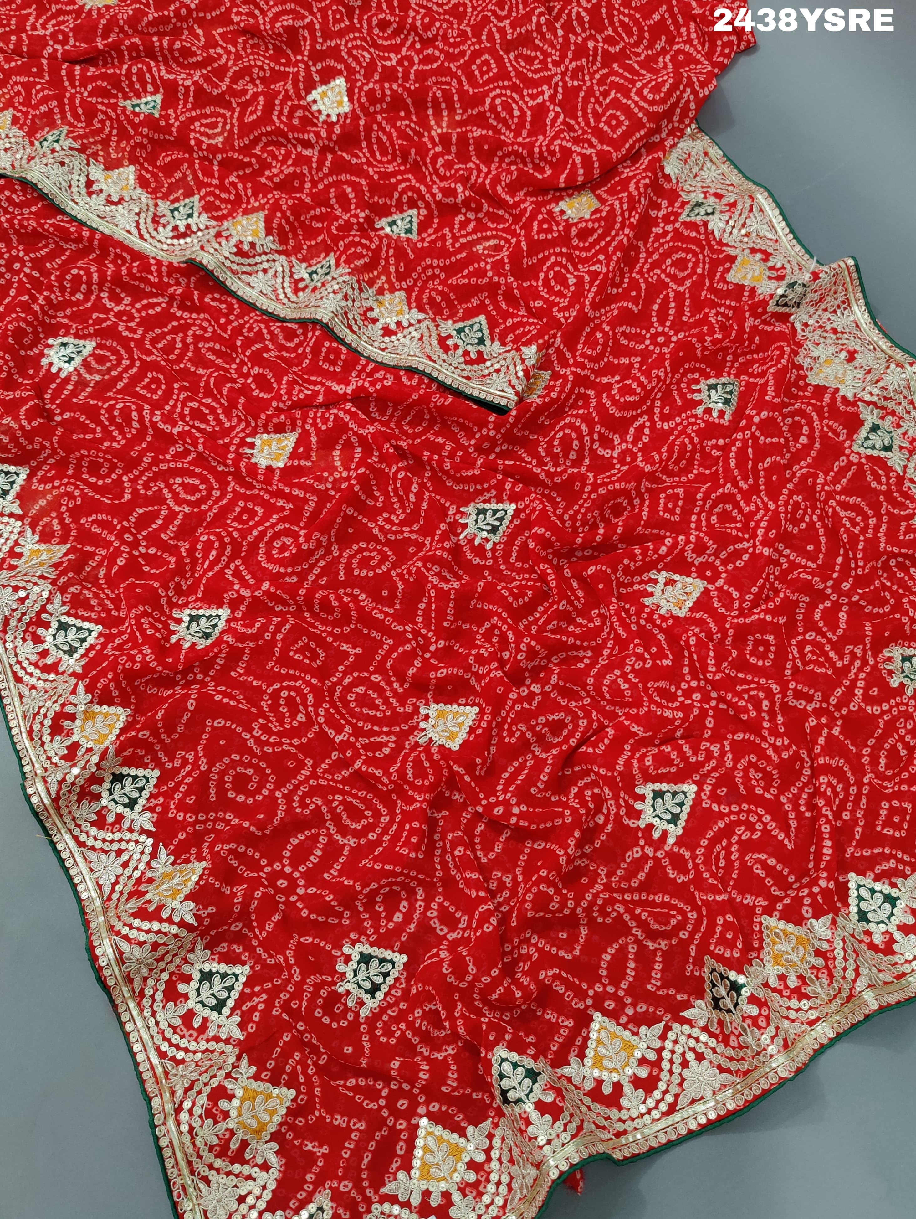 A red chiffon saree with bandhani pattern and gotapatti work