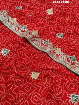 A red chiffon saree with bandhani pattern and gotapatti work