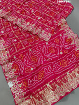 Apink saree with a bandhani pattern and gota patti work.