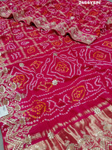 Apink saree with a bandhani pattern and gota patti work.