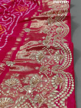 Apink saree with a bandhani pattern and gota patti work.