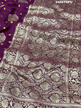 A purple Dola silk saree with detailed Zari weaving work and a Banarasi style pattern, including a wide border with similar ornate design.