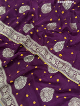 A purple Dola silk saree with detailed Zari weaving work and a Banarasi style pattern, including a wide border with similar ornate design.