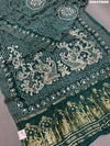 A green modal silk saree with bandhani style patterns and gotapatti work