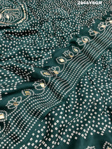 A green modal silk saree with bandhani style patterns and gotapatti work