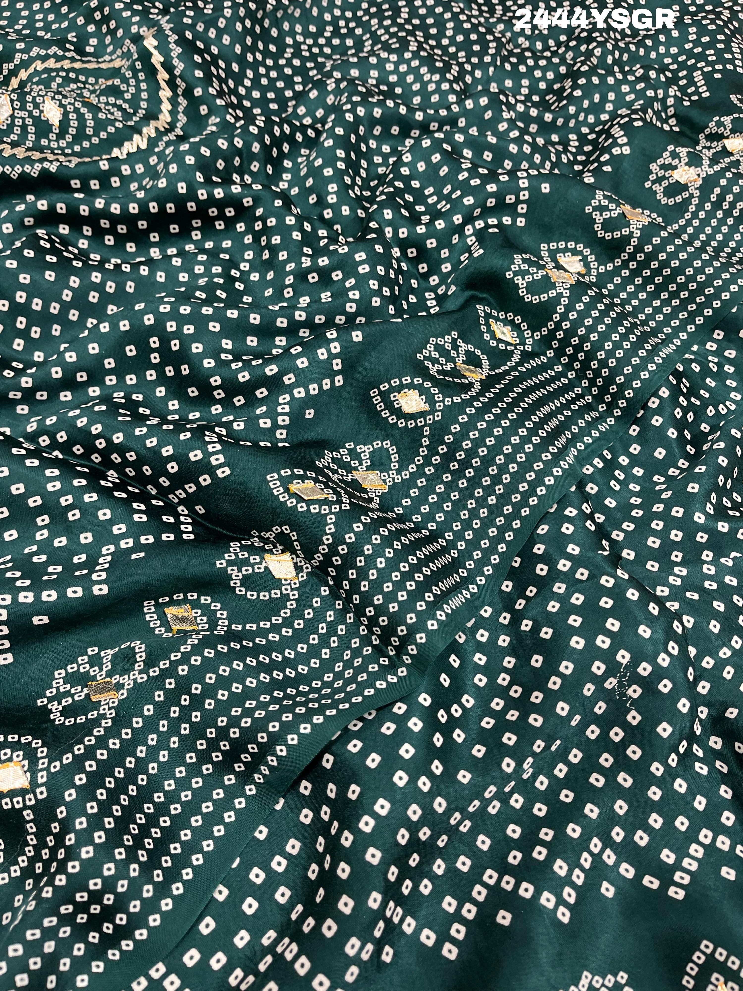 A green modal silk saree with bandhani style patterns and gotapatti work