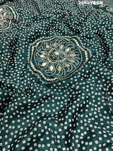 A green modal silk saree with bandhani style patterns and gotapatti work