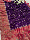 A purple and red Dola silk Banarasi saree with cutdana work, captured with a floral design at the border.