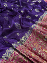 A purple and red Dola silk Banarasi saree with cutdana work, captured with a floral design at the border.