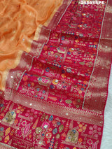 A Banarasi style saree with peach color and cutdana work, accompanied by a red and gold patterned border.