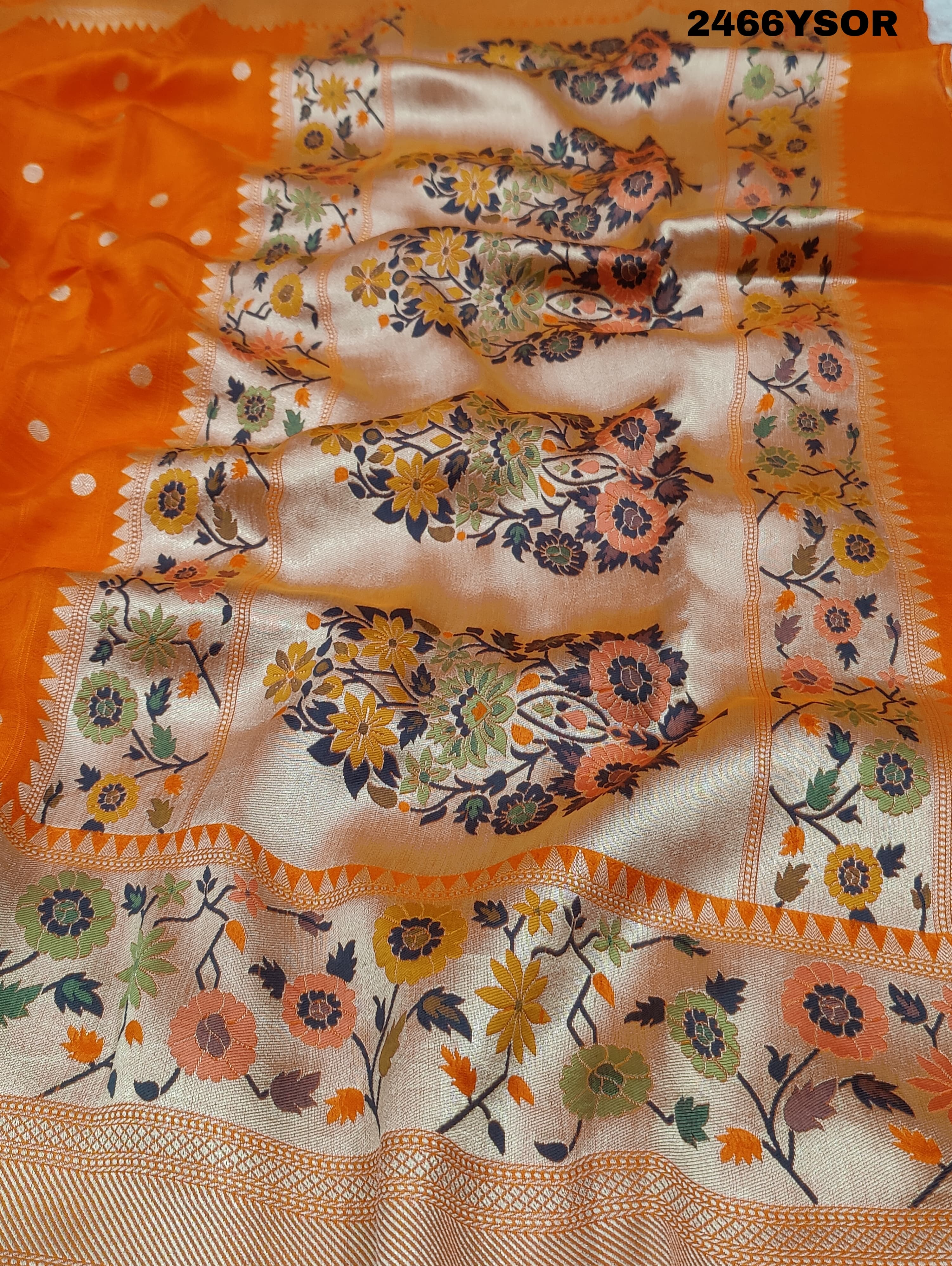 An orange Banarasi silk saree with floral printed style and zari weaving work