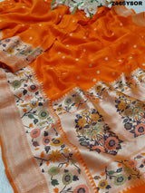 An orange Banarasi silk saree with floral printed style and zari weaving work