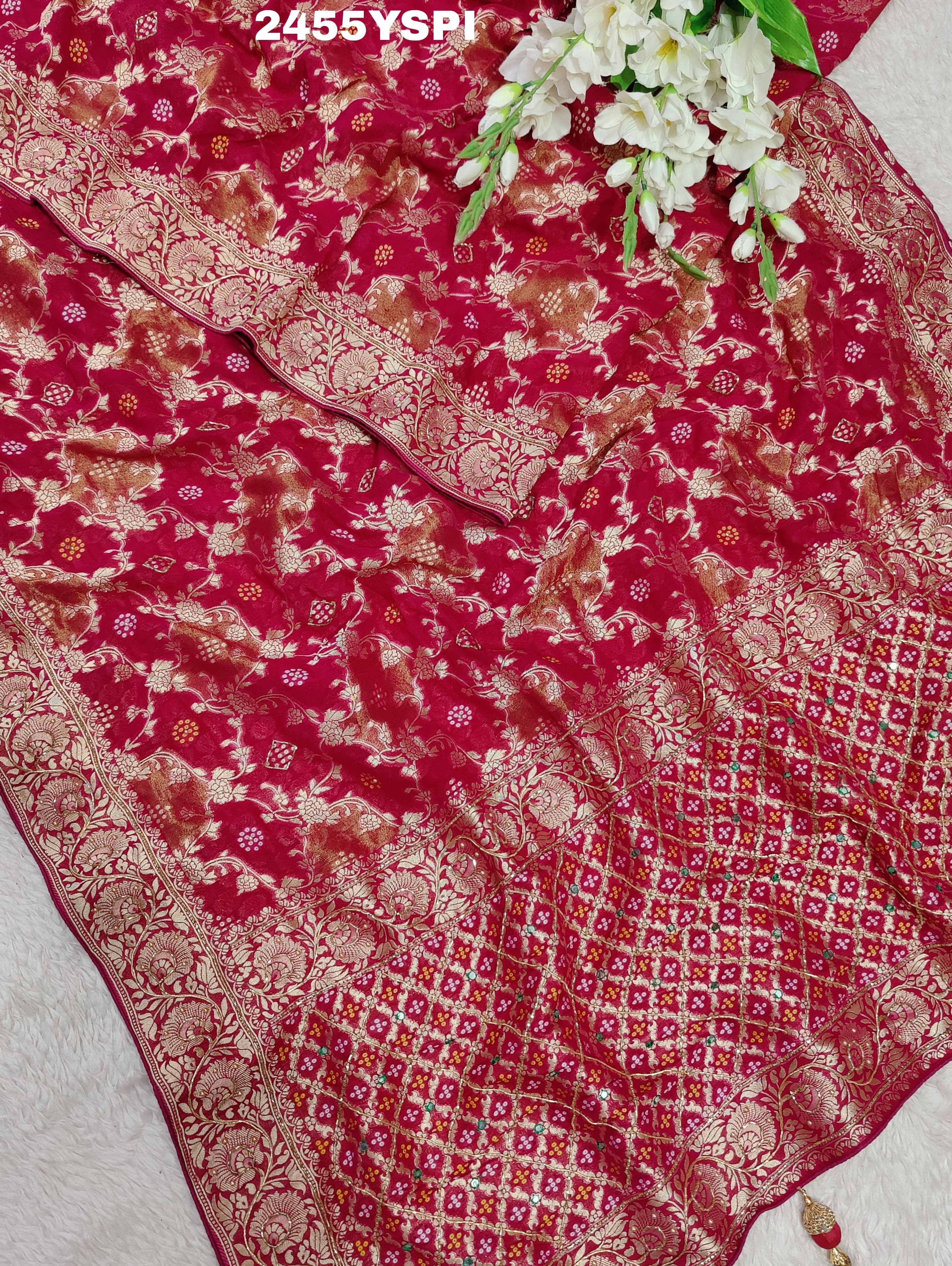 A Banarasi style saree with cutdana work, predominantly pink with gold geometric patterns
