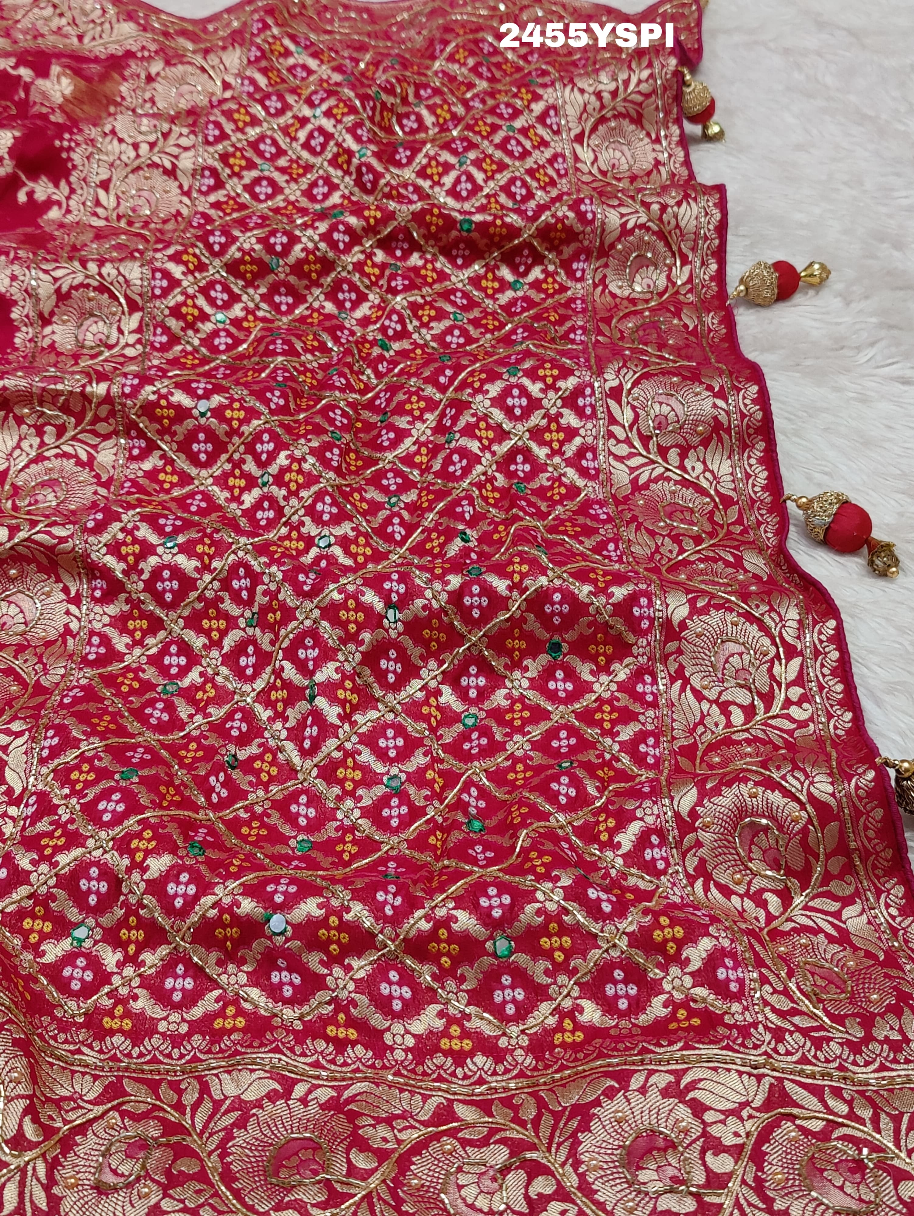 A Banarasi style saree with cutdana work, predominantly pink with gold geometric patterns