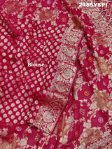 A Banarasi style saree with cutdana work, predominantly pink with gold geometric patterns