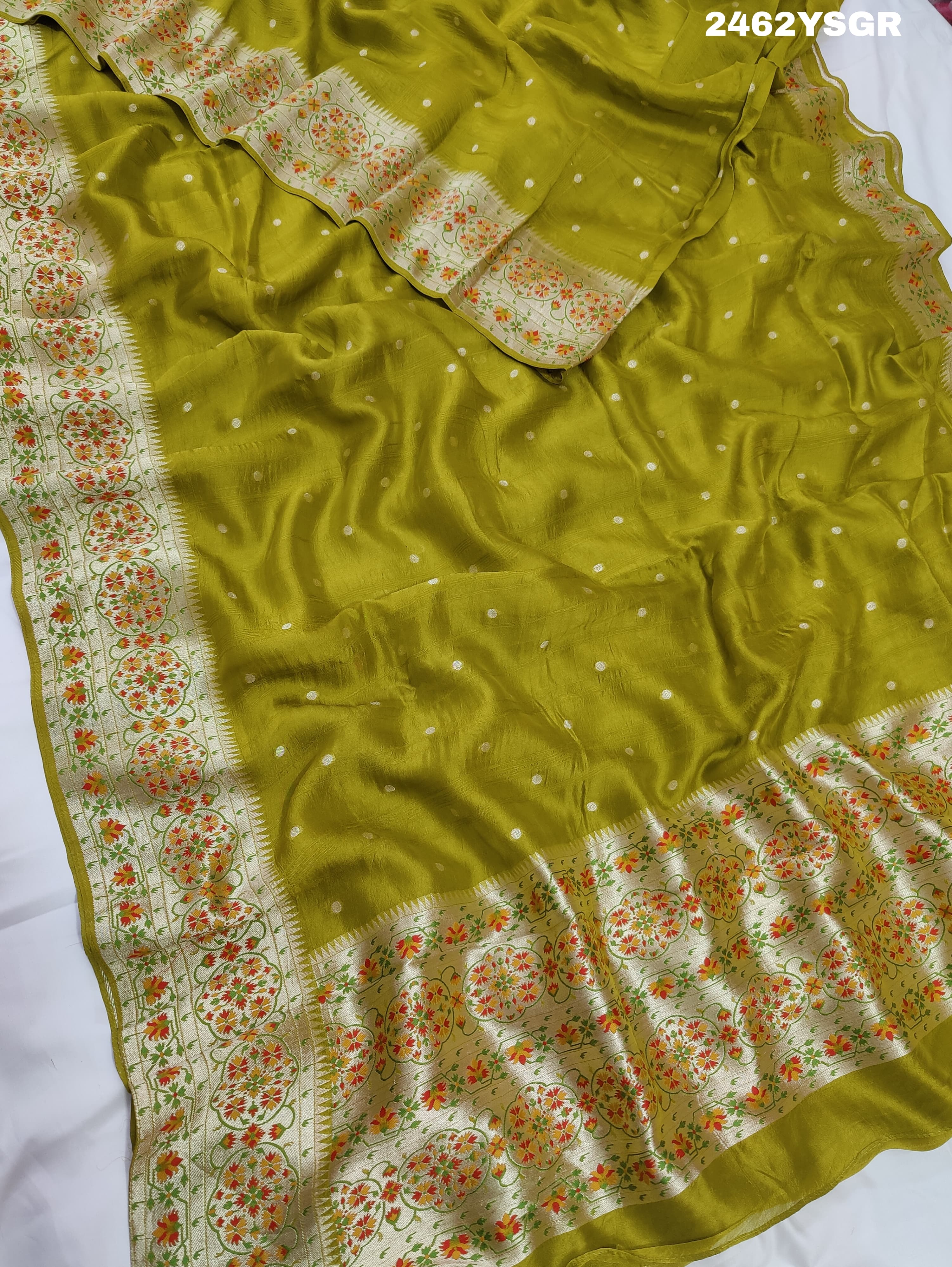A green Banarasi silk saree with zari weaving and floral embellishments, 