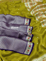 A green Banarasi silk saree with zari weaving and floral embellishments, 