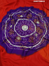 A saree with bandhani style patterns in red and green colors, featuring detailed gotapatti work.