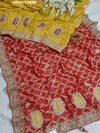 A Banarasi silk saree with sequence embroidery work, featuring a design in yellow and red patterns