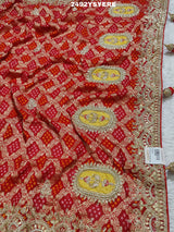 A Banarasi silk saree with sequence embroidery work, featuring a design in yellow and red patterns