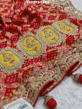 A Banarasi silk saree with sequence embroidery work, featuring a design in yellow and red patterns