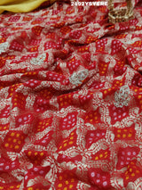 A Banarasi silk saree with sequence embroidery work, featuring a design in yellow and red patterns