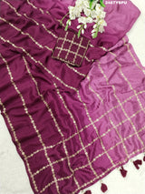 A purple Bollywood style silk saree with geometric pattern and pittan work
