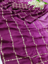 A purple Bollywood style silk saree with geometric pattern and pittan work